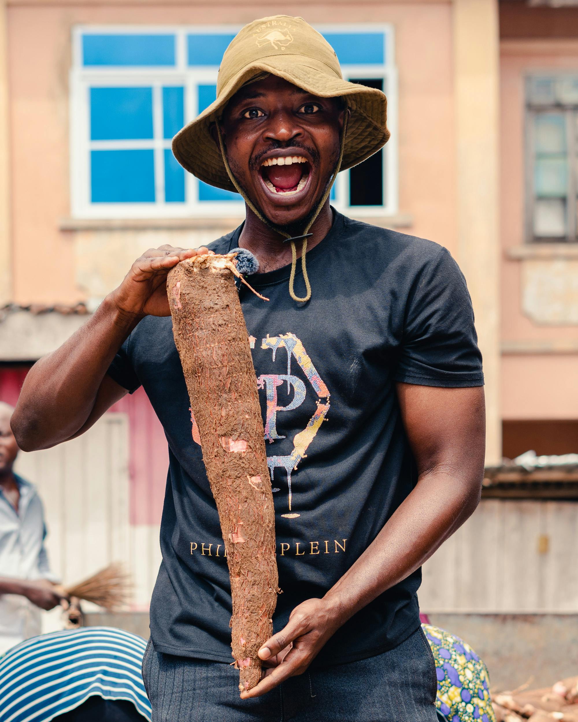 man holding cassava